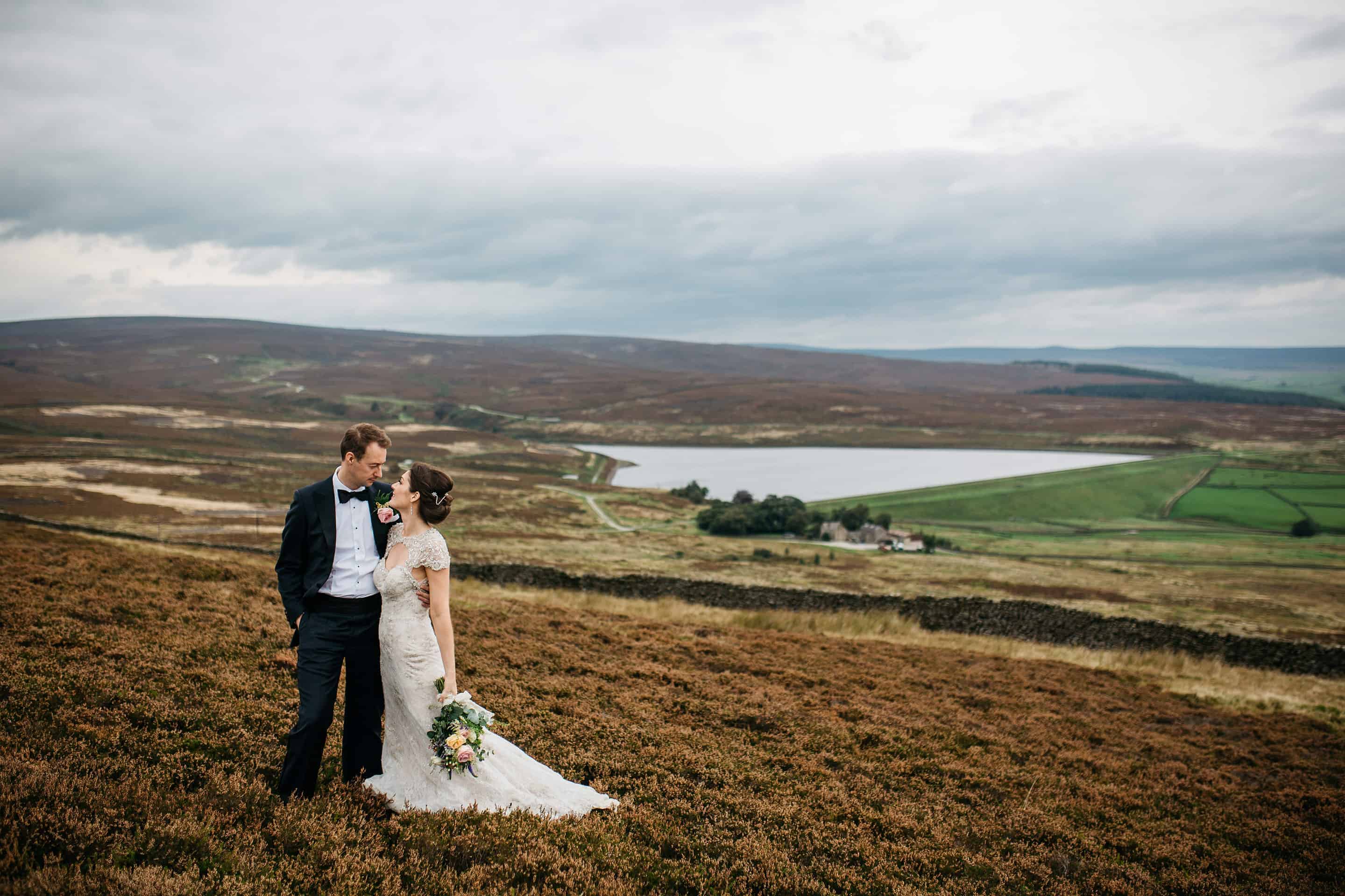 Bride and Groom posing in the moors on their wedding day, craigmar weddings yorkshire wedding photographer