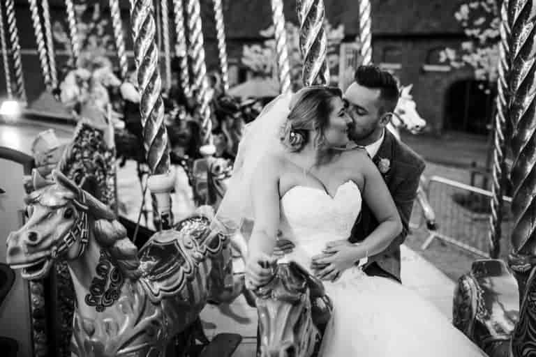 Black and white photo of Abby and Andy laughing together at their Elsham Hall wedding
