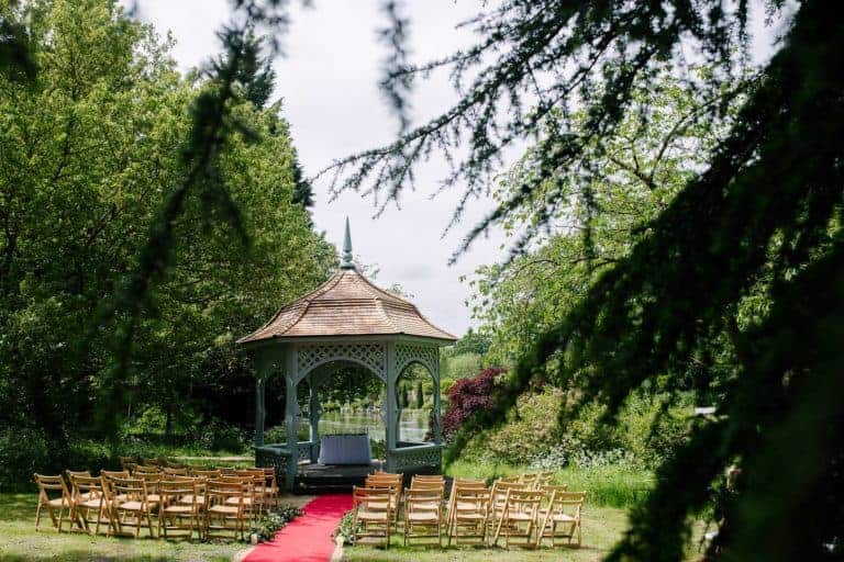 The white lakeside wedding pavilion at Elsham Hall set up for an outdoor ceremony