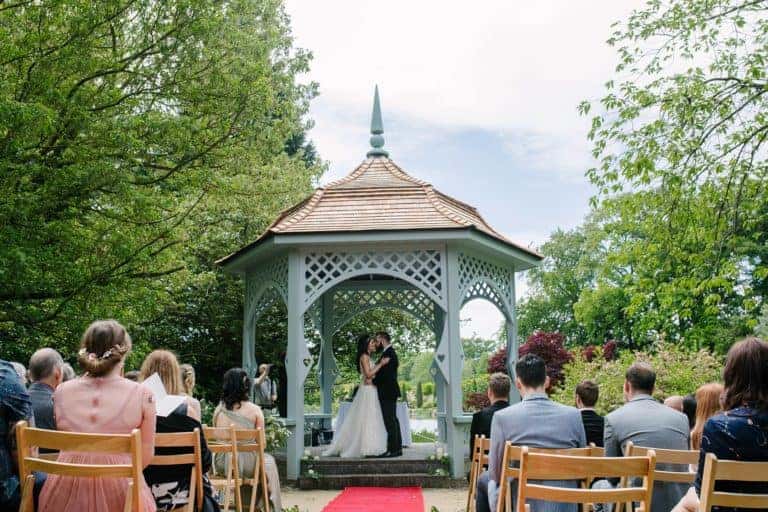 Outdoor wedding ceremony at the lakeside pavilion at Elsham Hall, North Lincolnshire