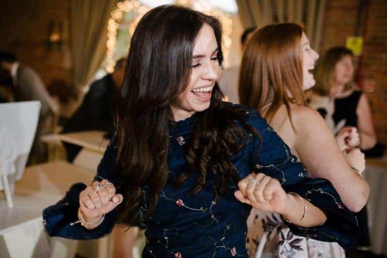 Wedding guest laughing and dancing at the evening party at Elsham Hall