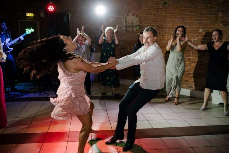 Bride being spun around the dance floor in the Elsham Hall barn