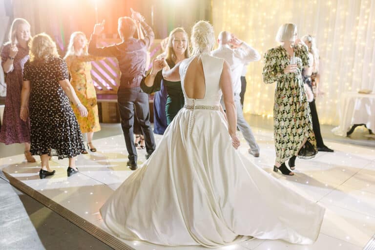 Bride twirling her wedding dress on the dance floor at her Bunny Hill winter wedding