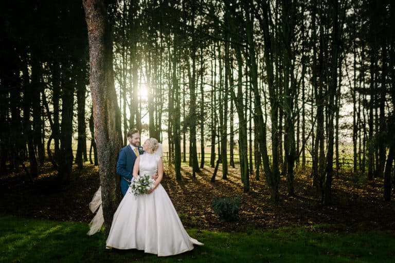Bride and groom in the pine woodland at Bunny Hill on their winter wedding day in North Cliffe, East Yorkshire