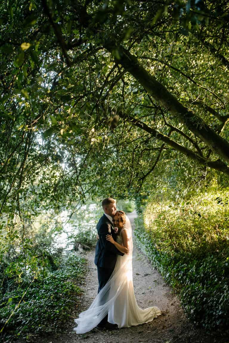 Bride and groom under the trees in the grounds of Elsham Hall – relaxed Elsham Hall wedding photography