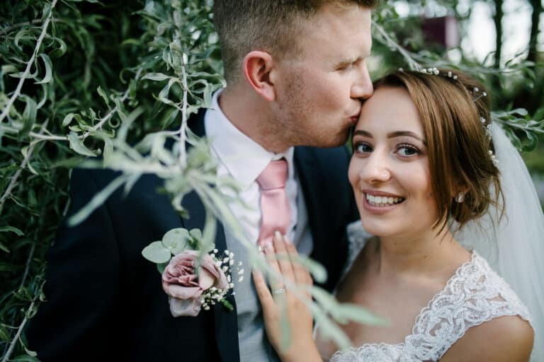 Katherine and Ben smiling together in the gardens at Elsham Hall