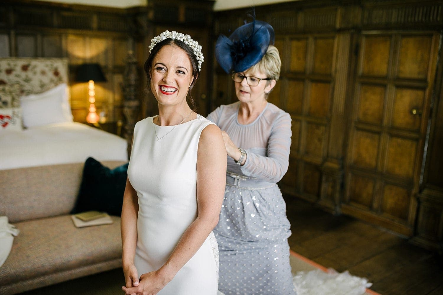 Bride at Dorfold Hall being helped by her mum in thr King James I bridal suite