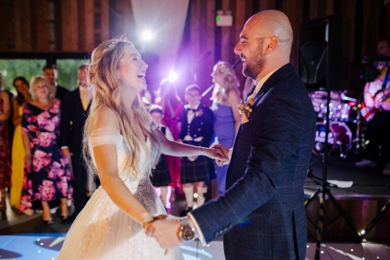 Bride and groom’s first dance under purple lights in the barn at Bunny Hill wedding venue, East Yorkshire