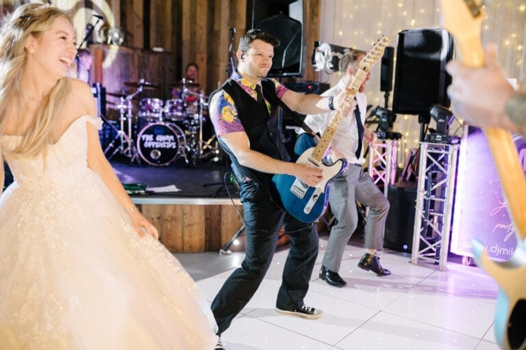 Bride dancing in front of the live band’s guitarist on the dance floor at Bunny Hill