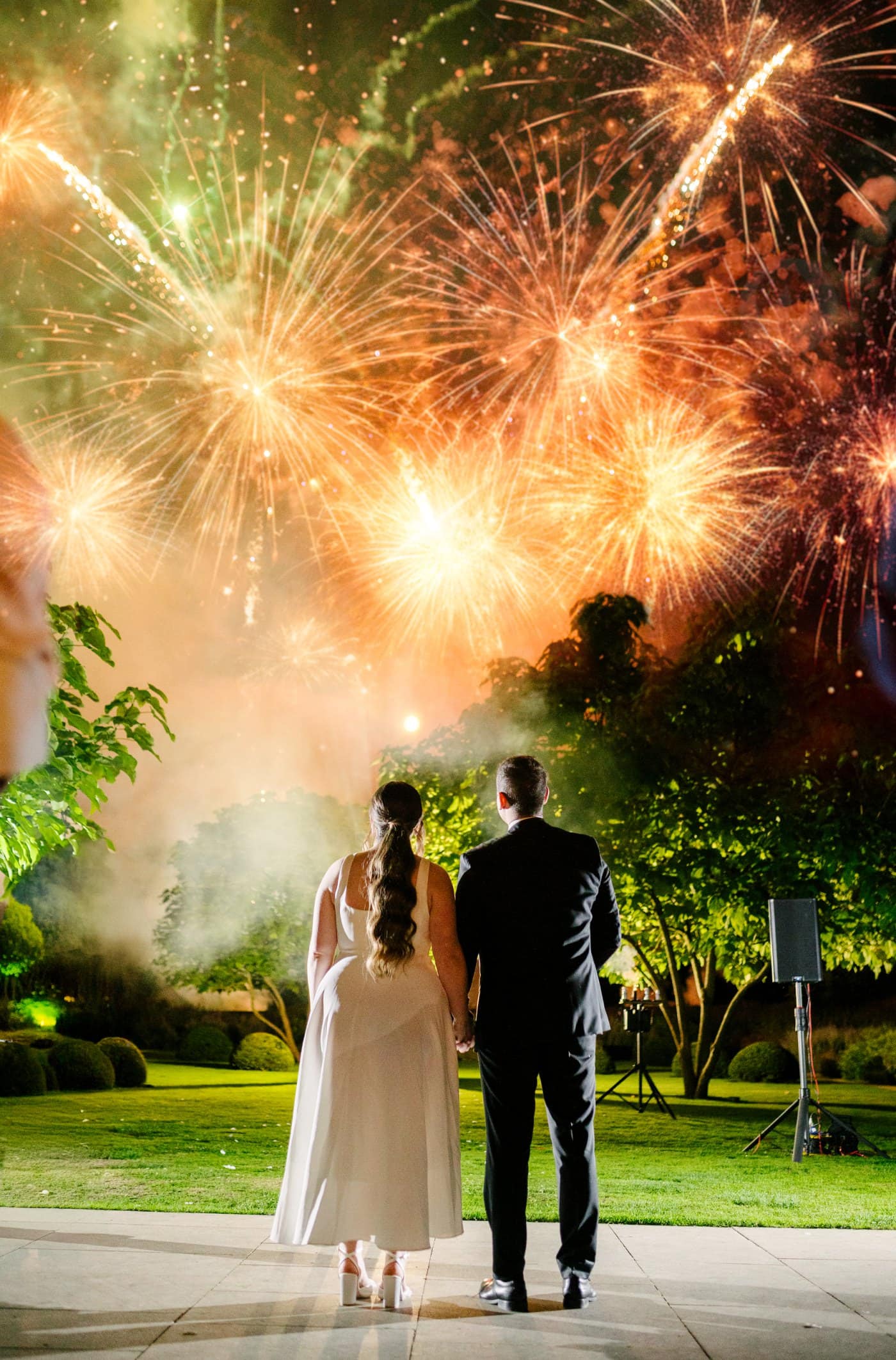 couple standing in front of fireworks that extra touch