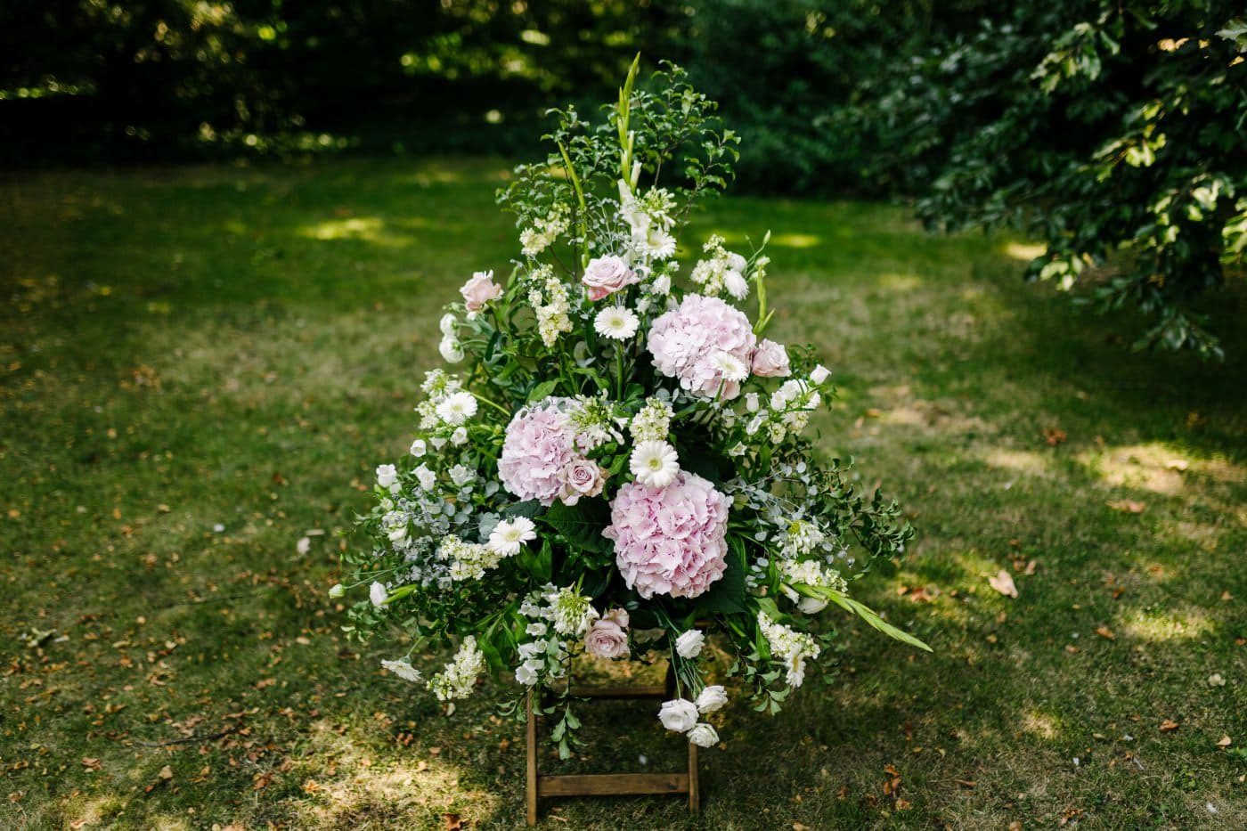 Lush gardens provide a serene setting for a delicate wedding and whimsical weddings moment, where nature and romance intertwine.