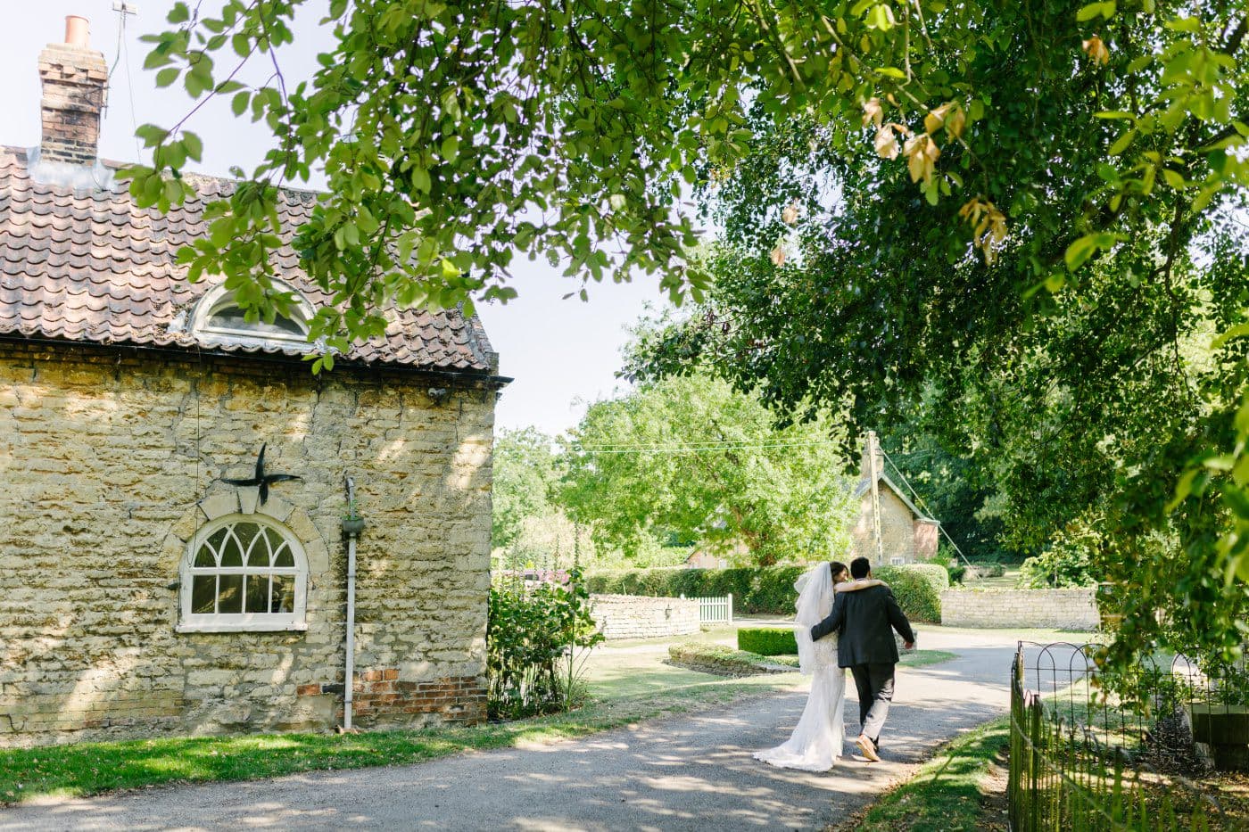 The hackthorn walled garden offers a serene retreat, where laughter, love, and timeless photos capture the couple’s radiant smiles.