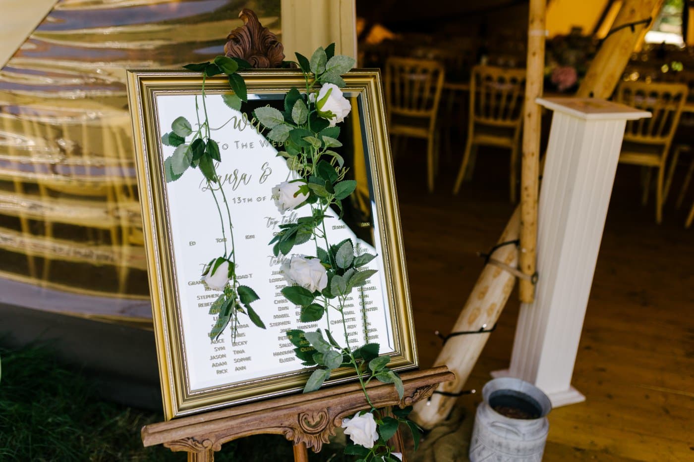 Laura and Nicholas share a tender moment under the radiant sun, with vibrant blooms and rustic charm framing their joyful expressions.