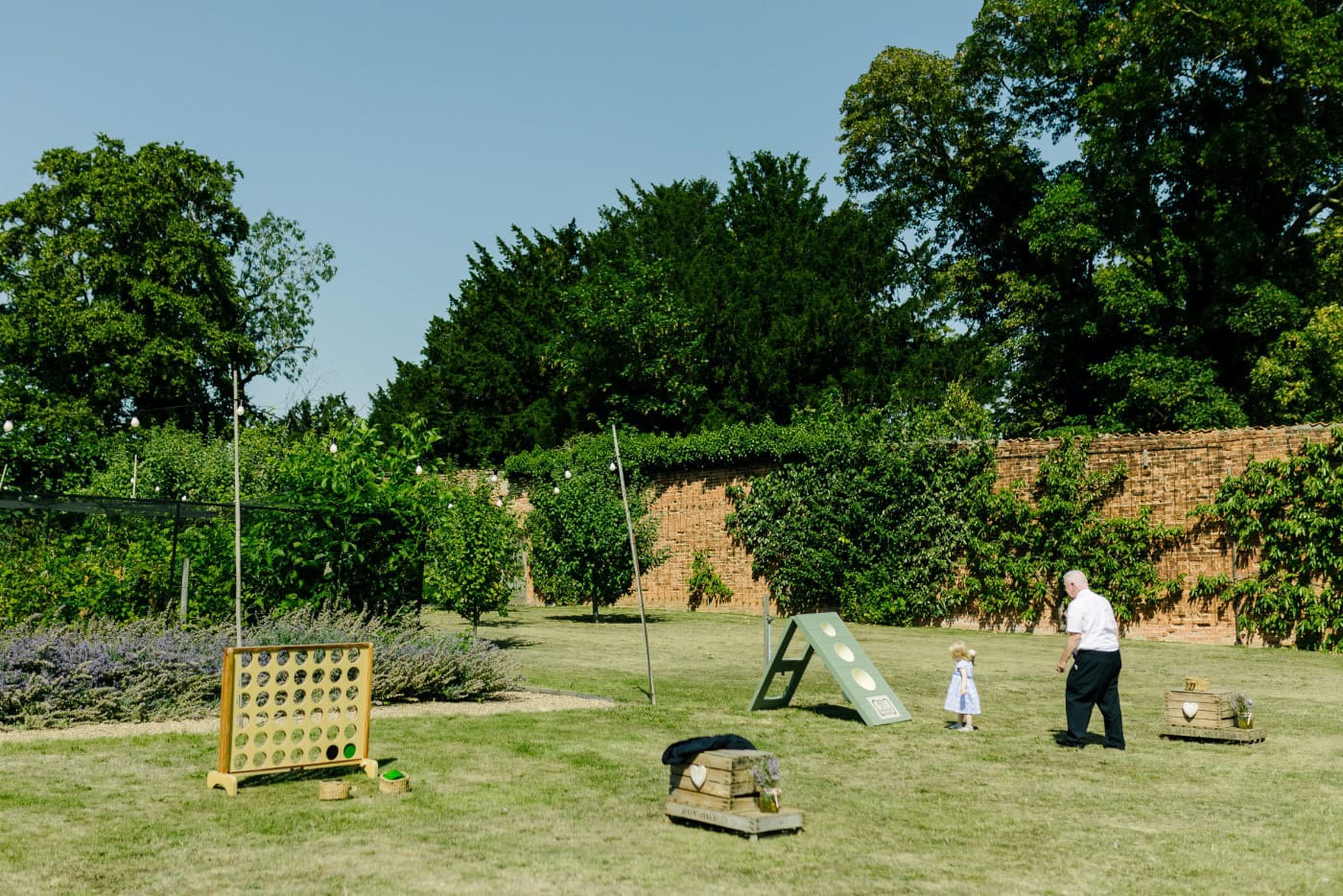 Under a canopy of trees, delicate light filters through to highlight joyful expressions and lasting memories.