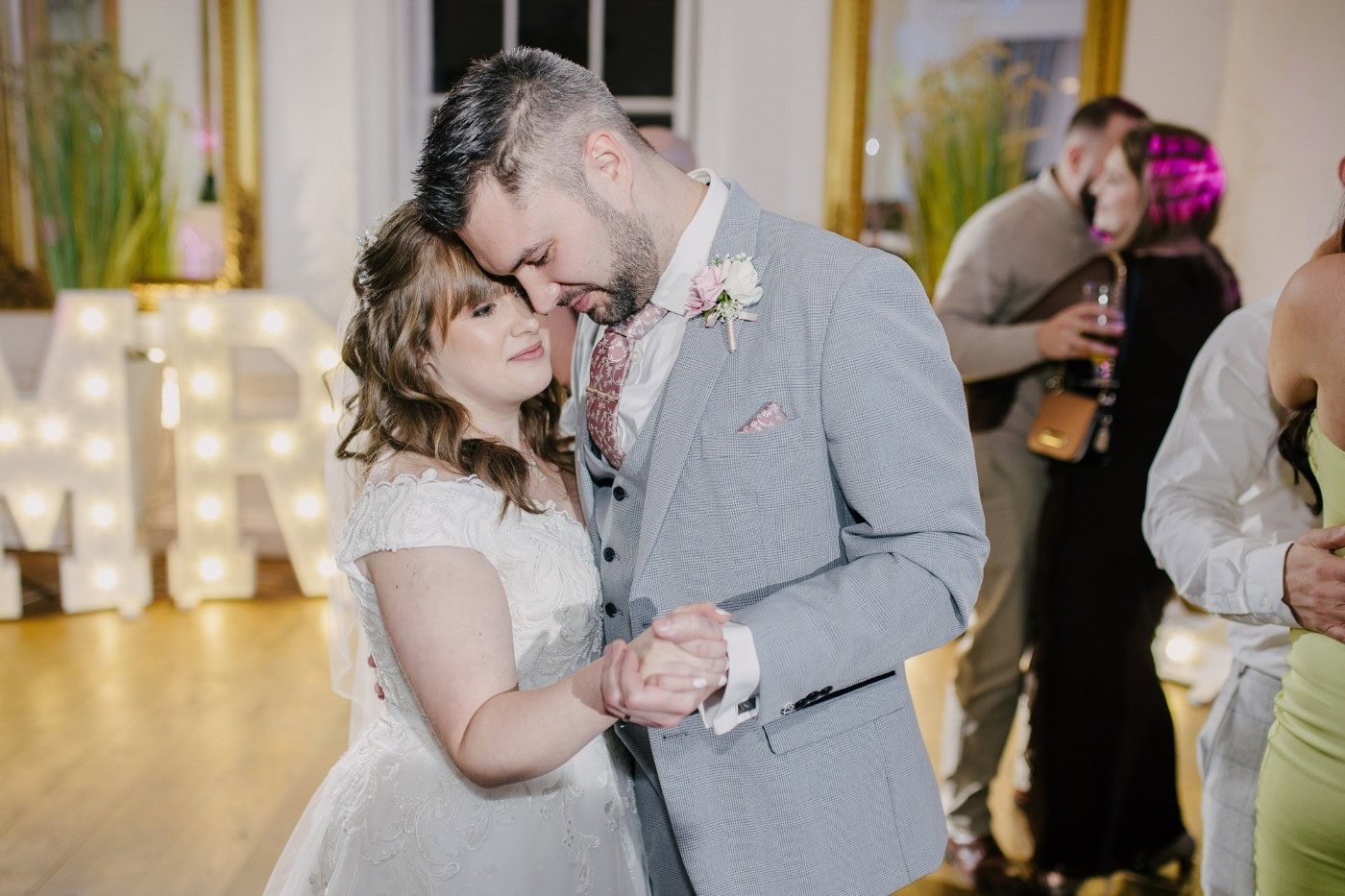The bride and groom close together during their first dance