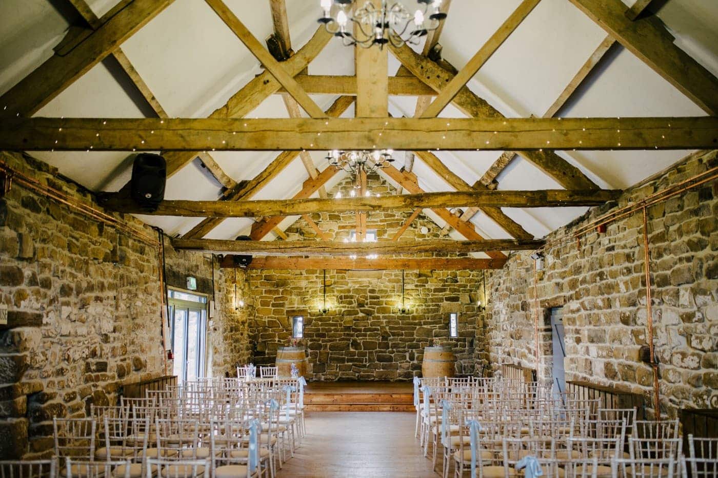 Stone barn at Danby Castle set with chandeliers for the wedding ceremony