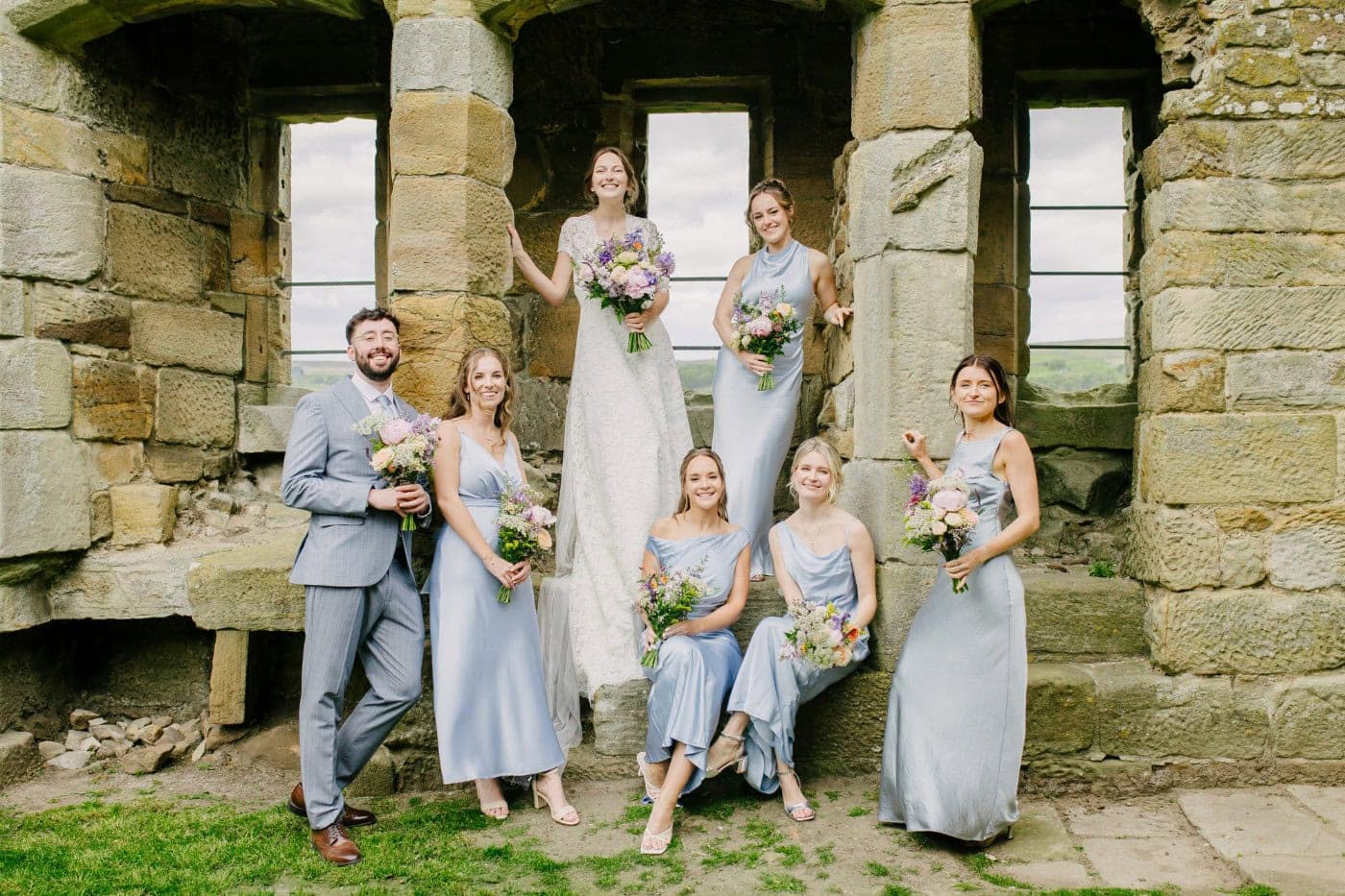 Ellie and George with their bridesmaids and groomsmen in the castle ruins at Danby Castle