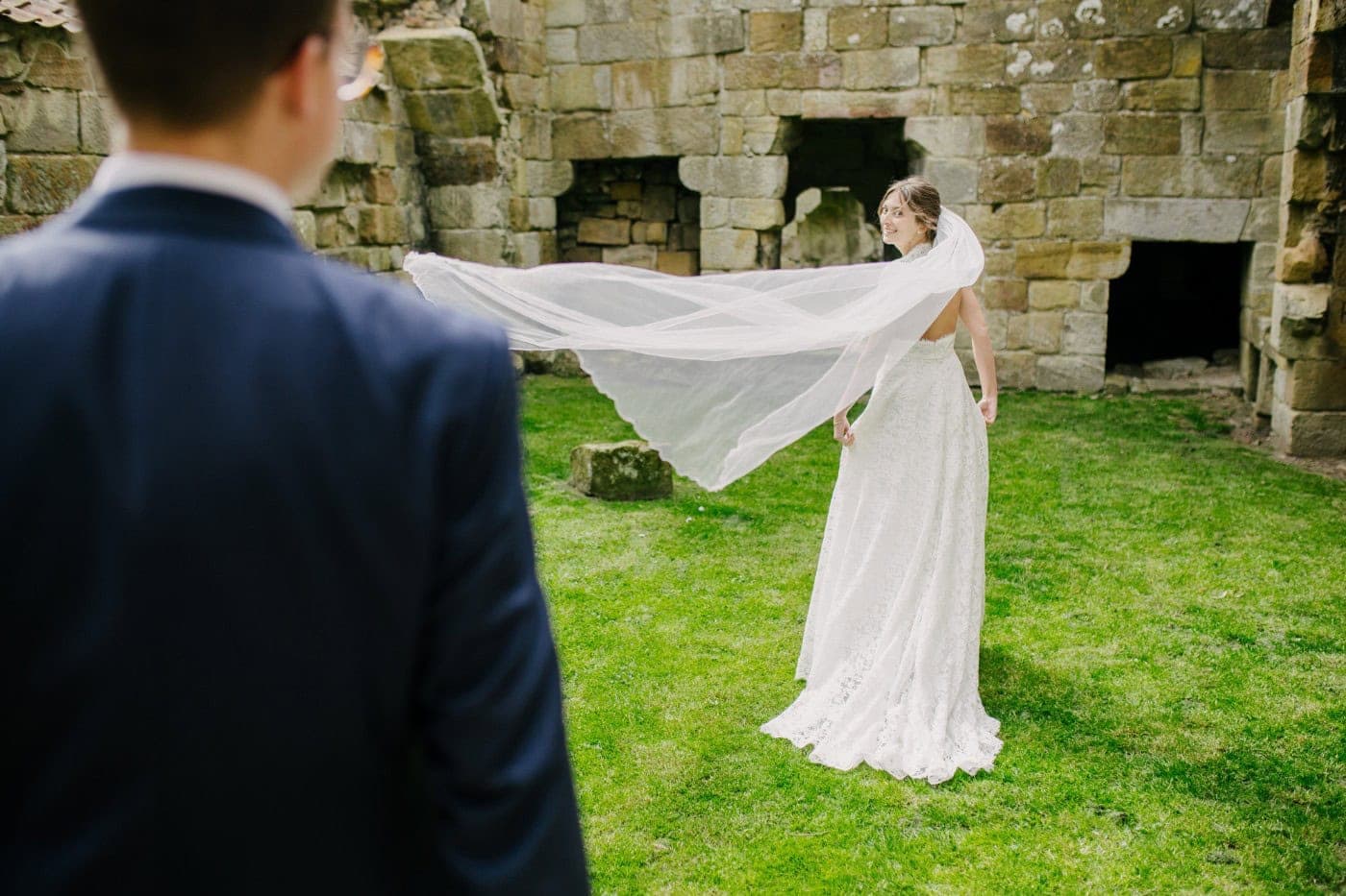 Ellie's veil caught in the wind in the castle ruins, a perfect moment
