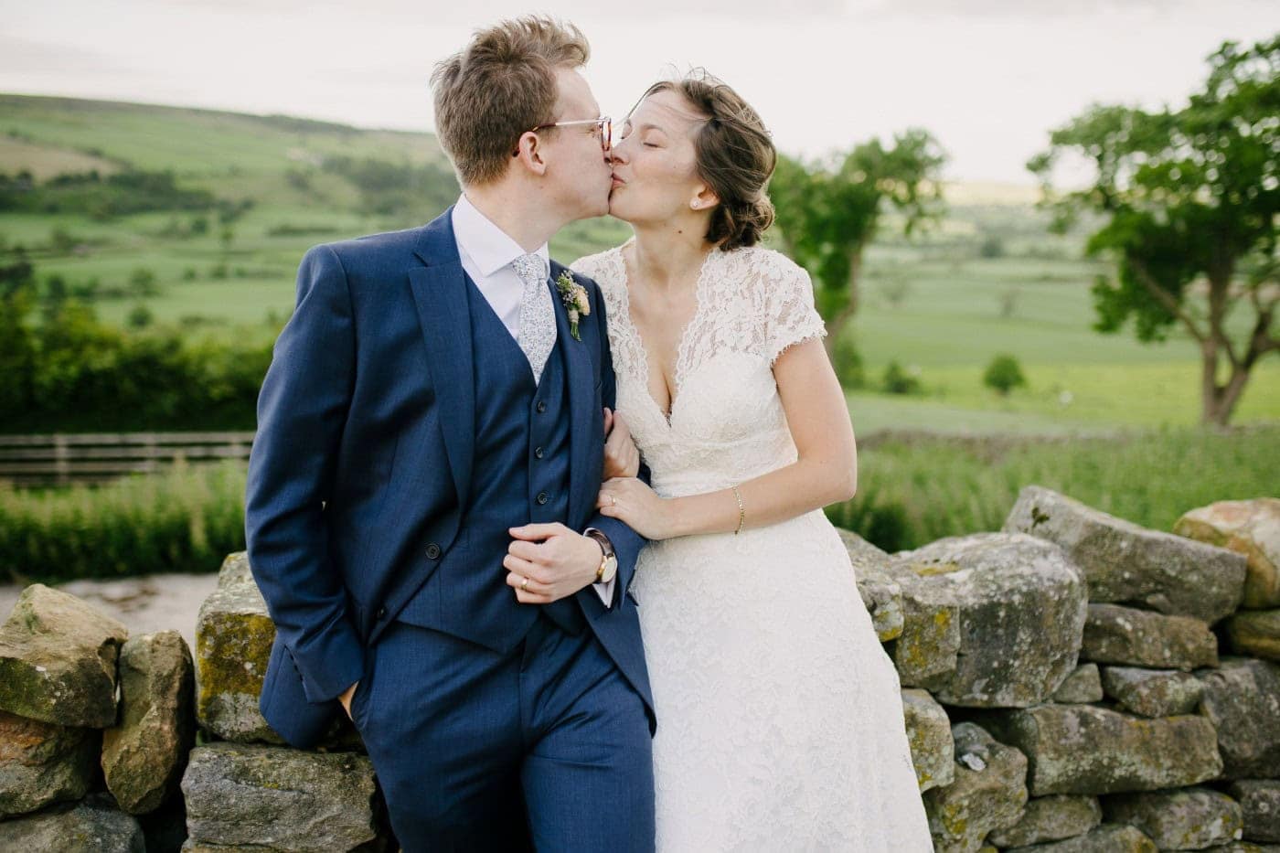 Ellie and George kissing with the North York Moors stretching out behind them