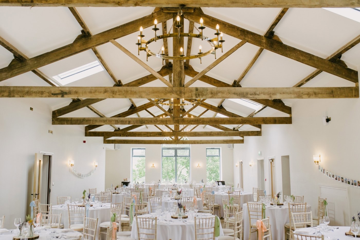 Reception room at Danby Castle set for the wedding breakfast with pastel flowers
