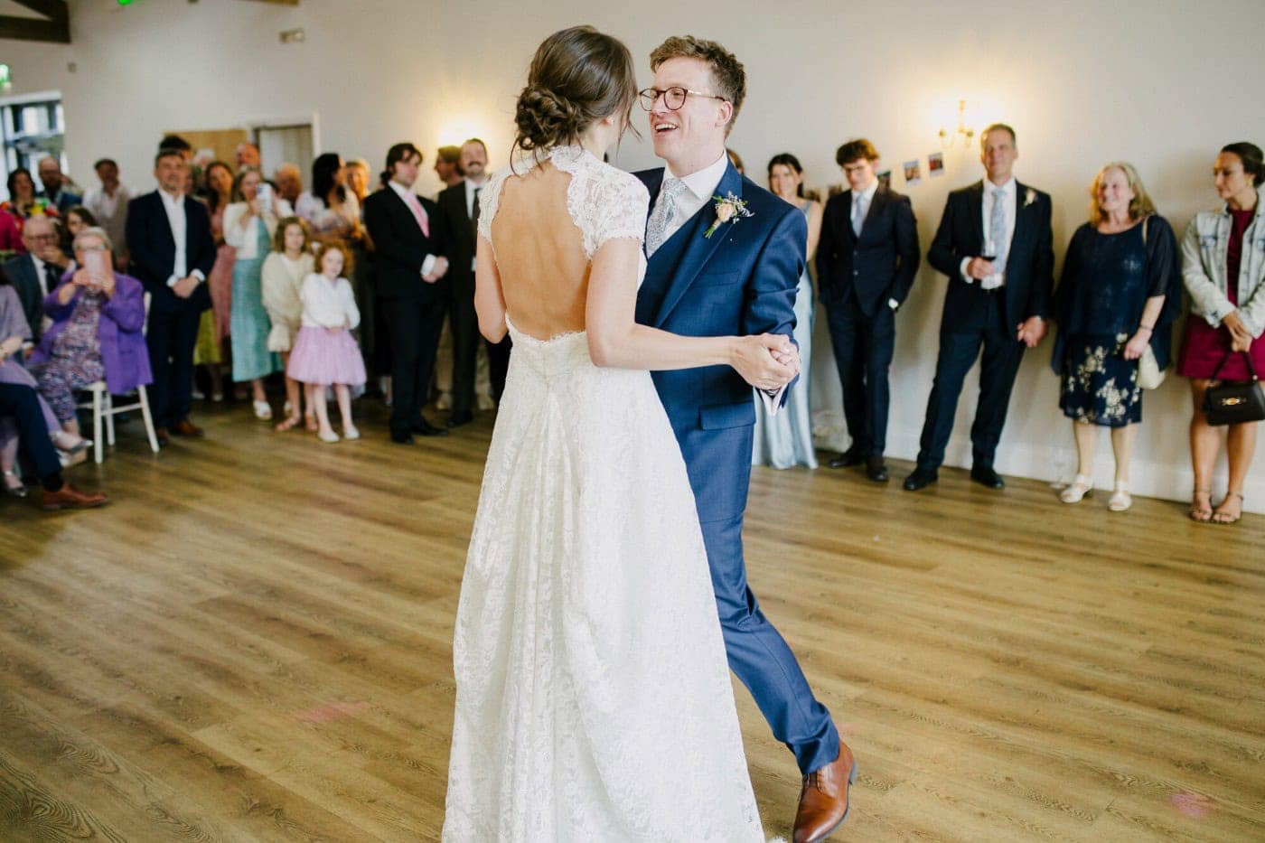 Ellie and George during their first dance under the chandeliers at Danby Castle