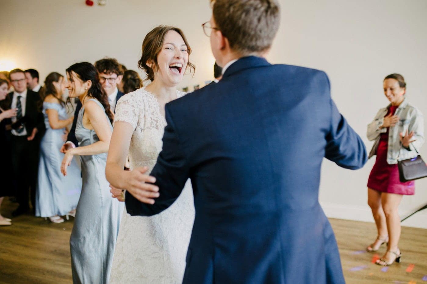Ellie laughing with George on the dance floor during their first dance