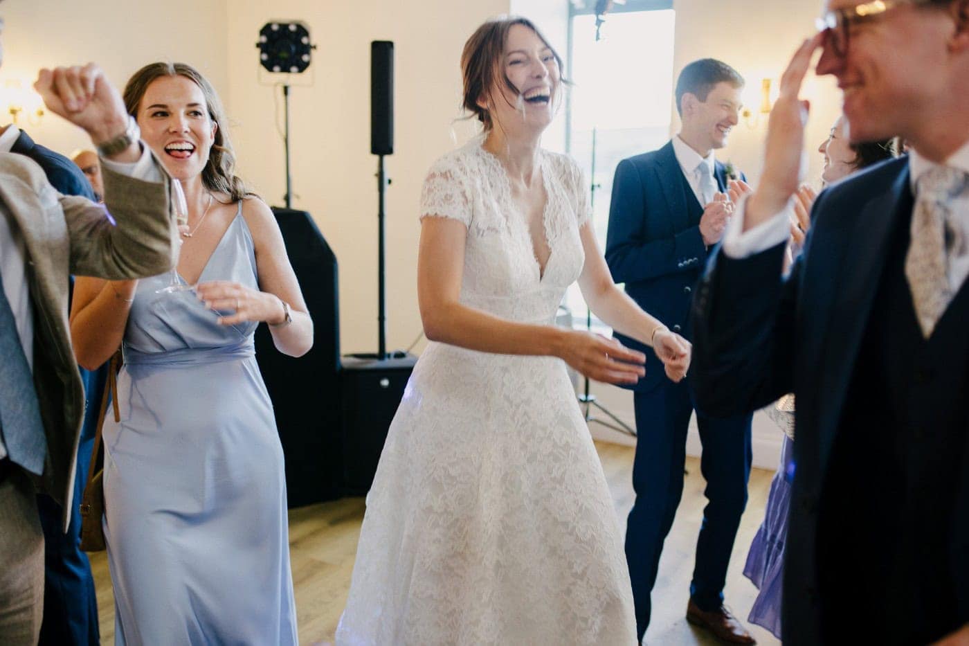 Ellie and her bridesmaids dancing together in the middle of the dance floor