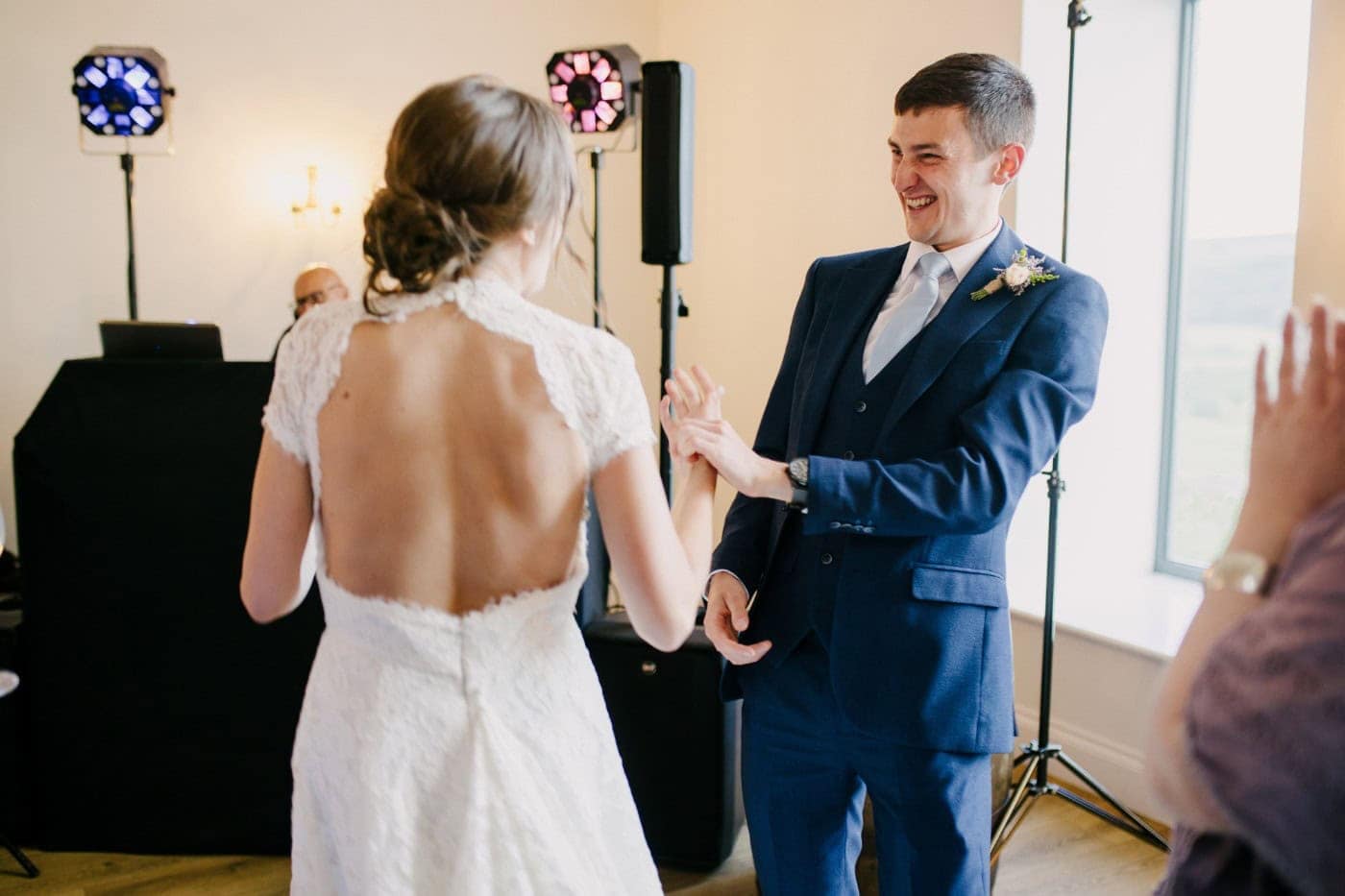 Ellie and George dancing together in the evening in the barn at Danby Castle
