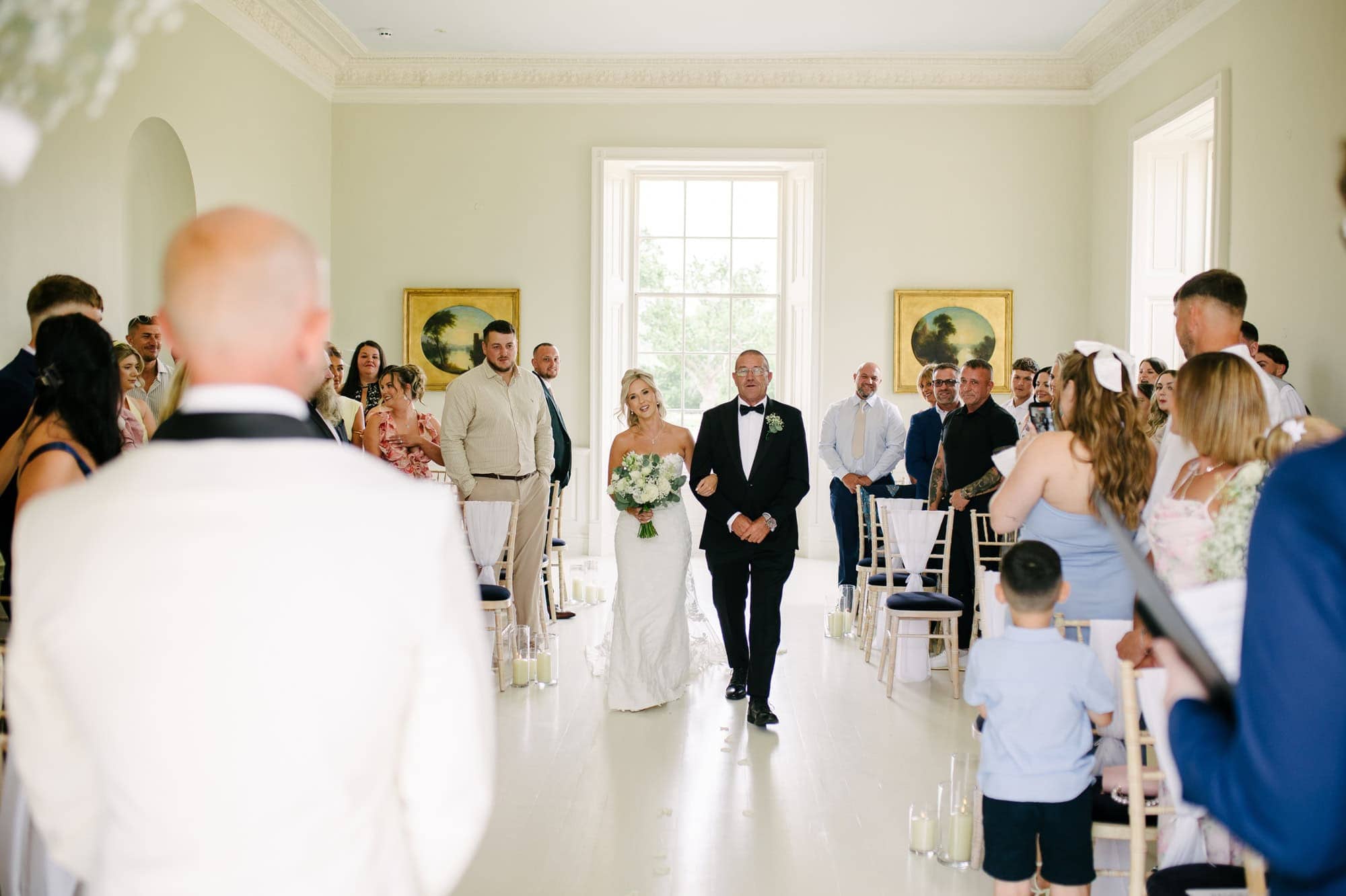 Kelly walking down the aisle with her dad at Stubton Hall as she sees Jake for the first time