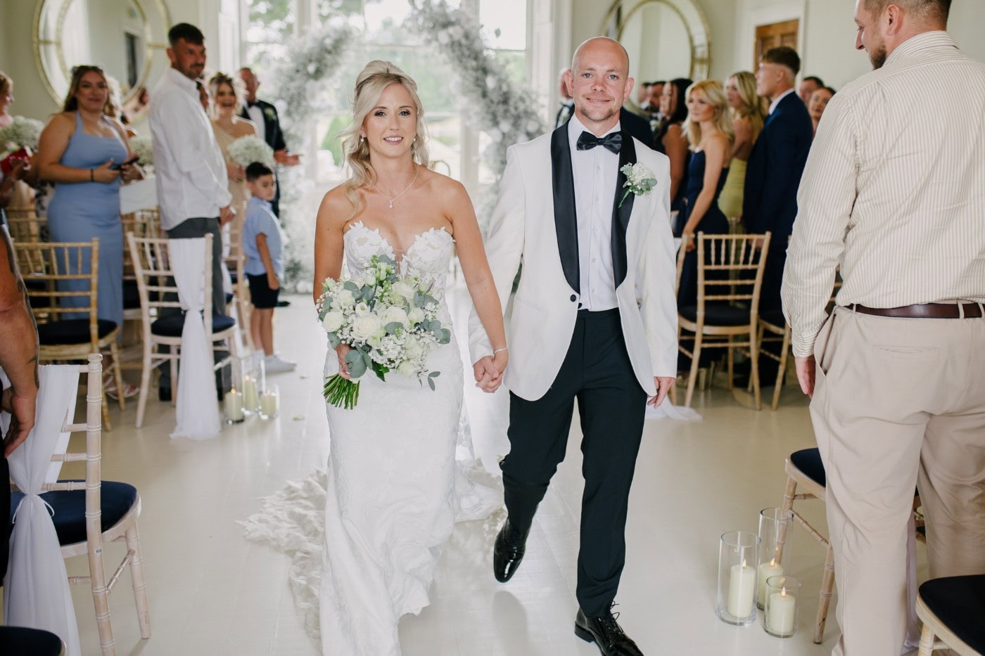 Bride and groom walking back up the aisle together as husband and wife